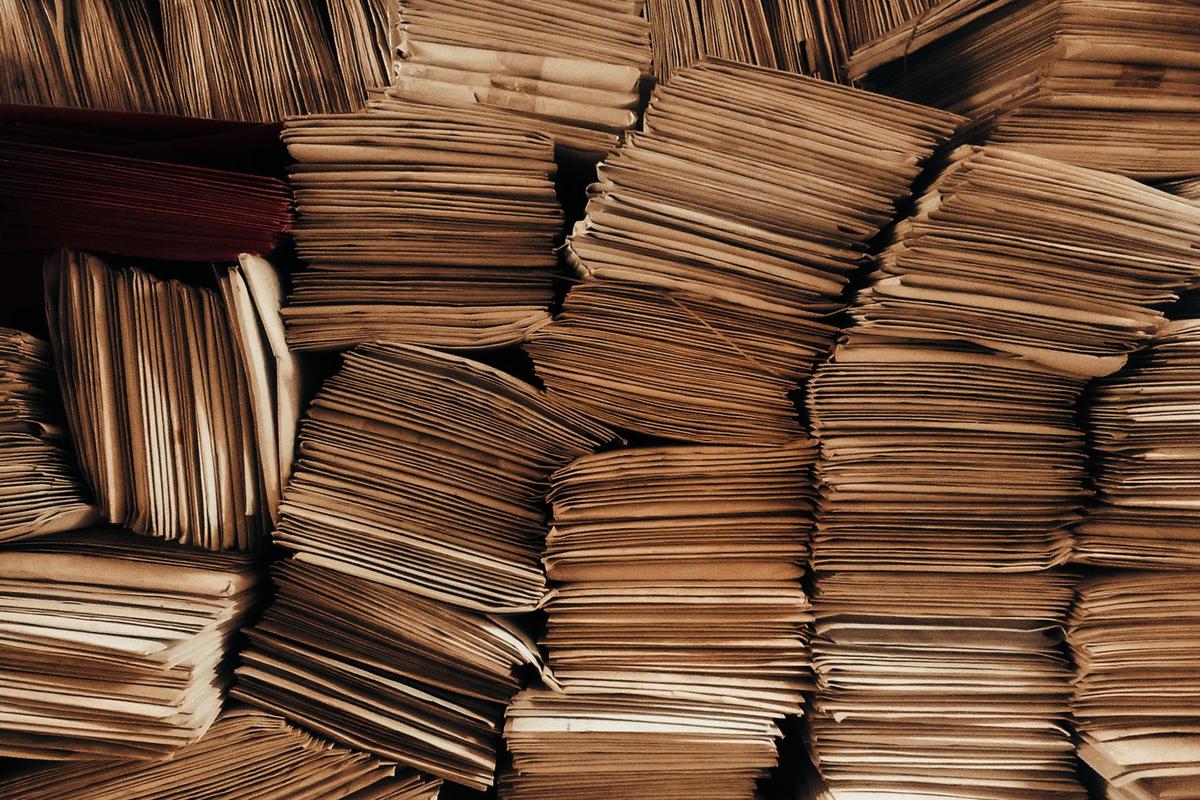 Wall of stacked brown envelopes filling the frame